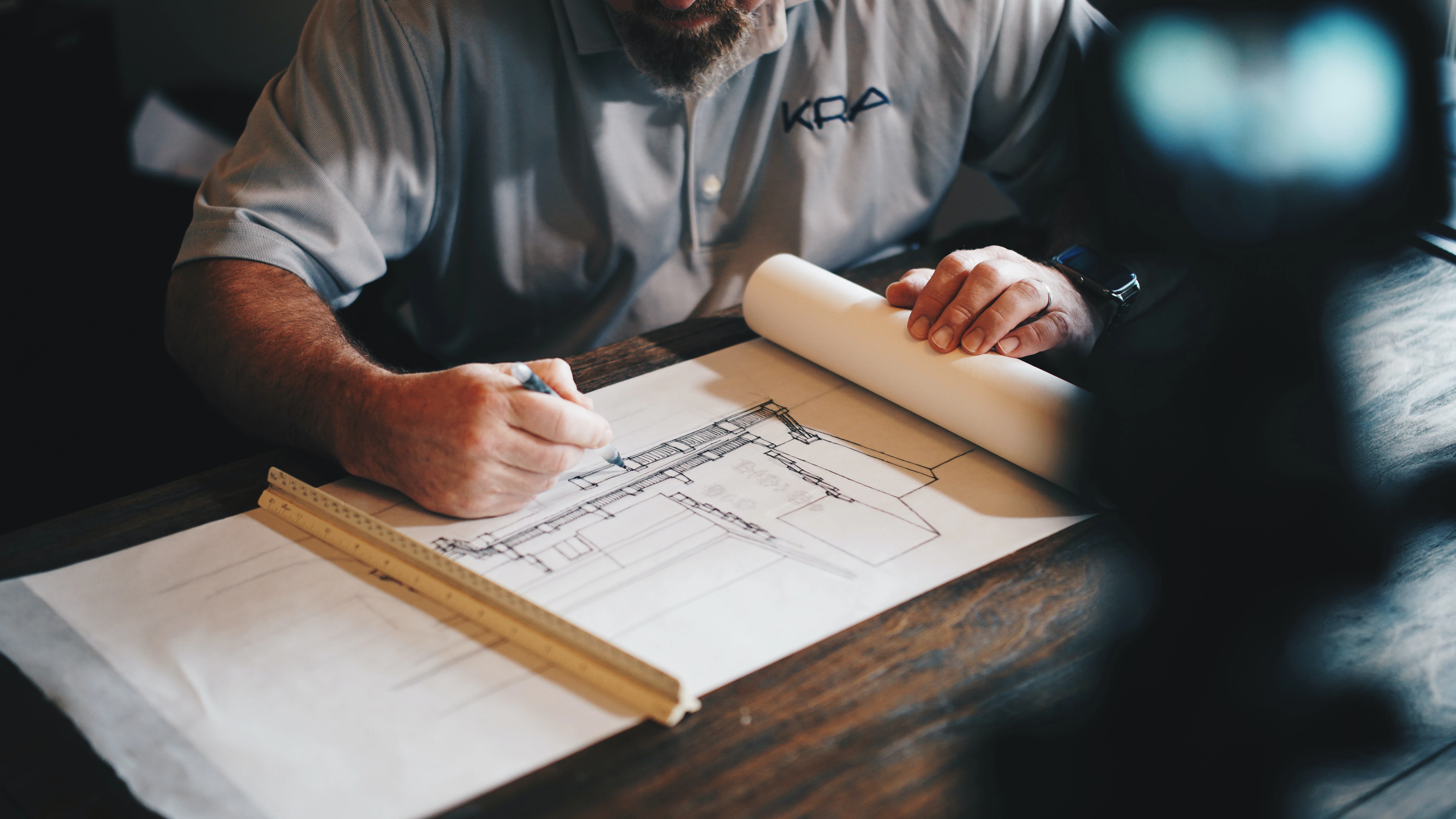 an architect working on a landed home design plan