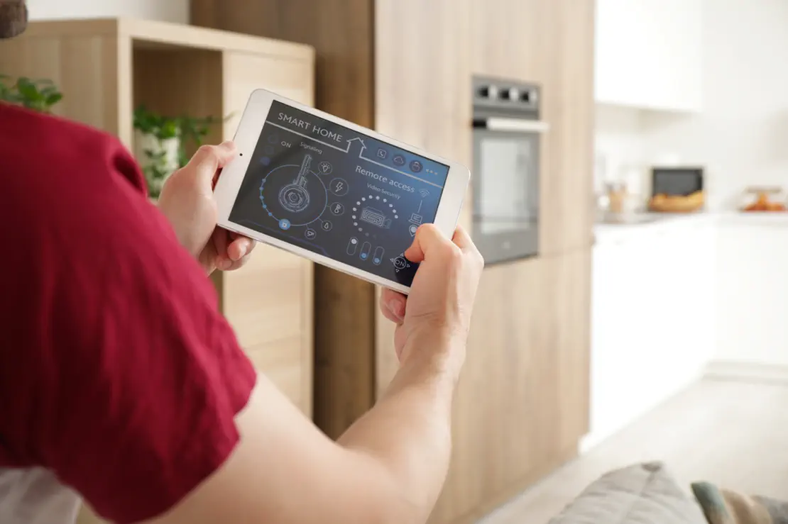 A Person Holding a Smart Home Control for a Landed House Design in Singapore | PCE Build